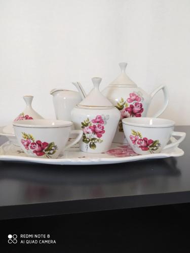 a group of tea cups and teapots on a plate at Pousada São Matheus- Lauro Müller-SC in Louro Müller