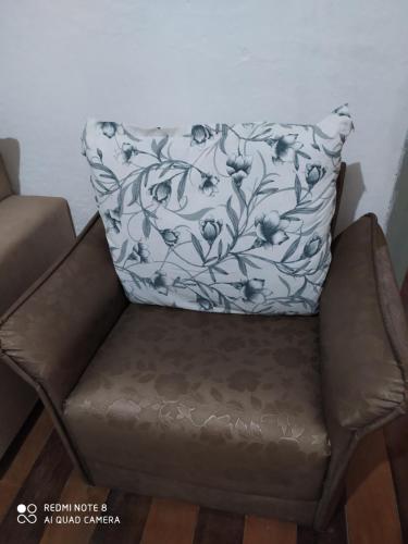 a chair with a pillow on top of it at Pousada São Matheus- Lauro Müller-SC in Louro Müller