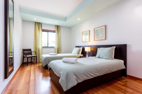 Postel nebo postele na pokoji v ubytování Baia da Luz - Great Light apartment