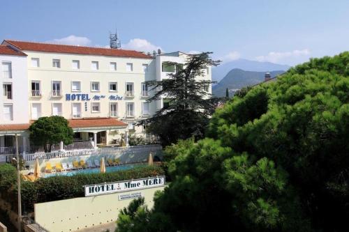 a large building with a sign on the side of it at Hotel Madame Mere in Saint-Florent