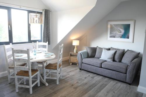 a living room with a couch and a table at The Harbour Retreat in Birdham