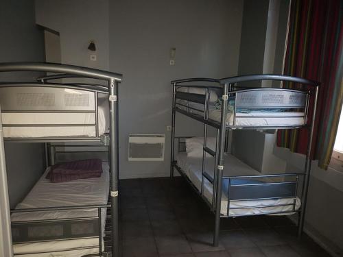 a room with three bunk beds in a room at HOTEL SYLVABELLE in Marseille