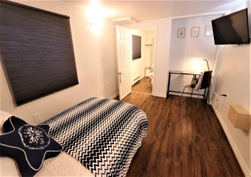 a bedroom with a bed with a black and white blanket at Illu B&B in Cambridge Bay