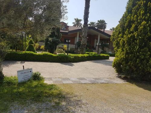 a house with a sign in front of a driveway at Agriturismo Terre Delle Monache in Pontecagnano