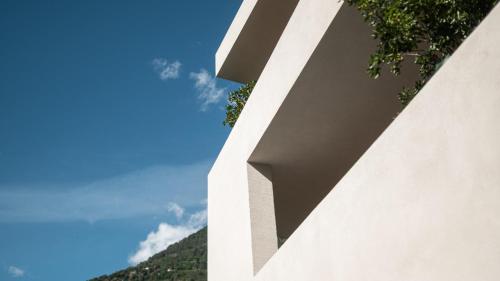 a close up of a white building with the sky in the background at Design Hotel Tyrol in Rablà
