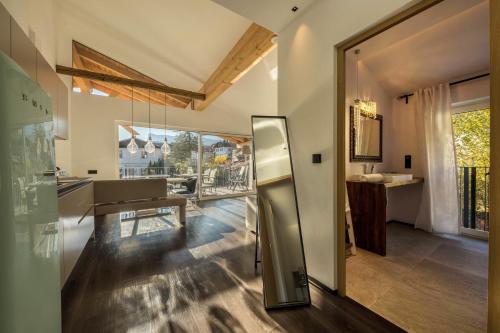 a kitchen with a stainless steel refrigerator and a dining room at latemar - schlosserhaus 31 in Tesimo