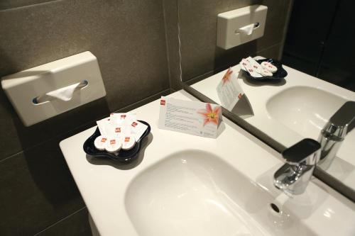 a bathroom with a white sink and a mirror at Hotel Riu Tikida Beach - Adults Only - All inclusive in Agadir
