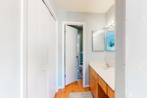 a white bathroom with a sink and a mirror at Sea Pines Village - 5 Sea Pines Village in Bethany Beach