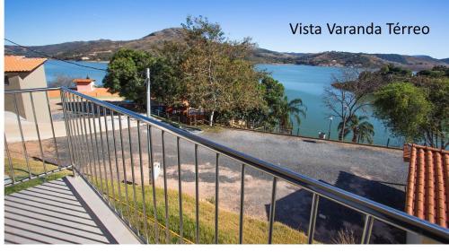 a view of a lake from the balcony of a house at Pousada Mar de Minas in Capitólio