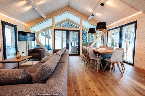 a living room with a couch and a table at Bergresort Hauser Kaibling by ALPS RESORTS in Haus im Ennstal