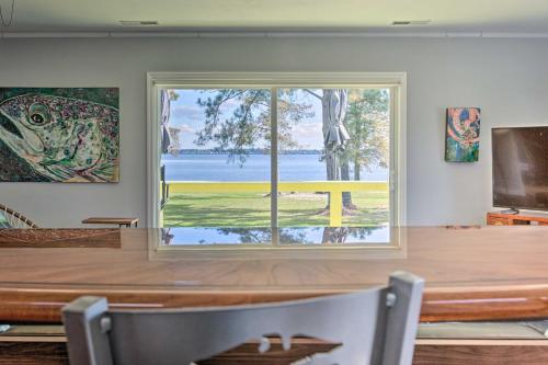 a large window in a dining room with a table at Riverfront New Bern House Gourmet Kitchen and View! in New Bern