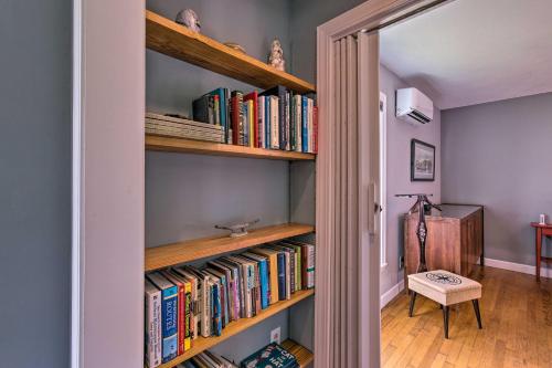 a hallway with wooden shelves filled with books at Riverfront New Bern House Gourmet Kitchen and View! in New Bern