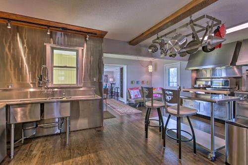 a large kitchen with stainless steel appliances and wooden floors at Riverfront New Bern House Gourmet Kitchen and View! in New Bern