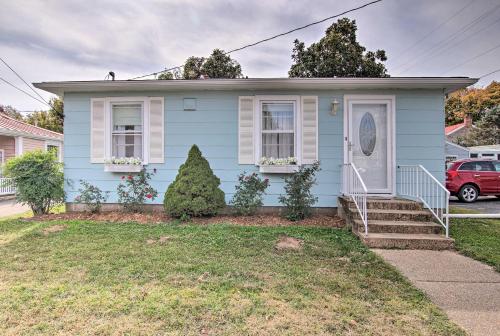 a blue house with a white door at Cottage with Yard, Walk to Historic Attractions in Sainte Genevieve