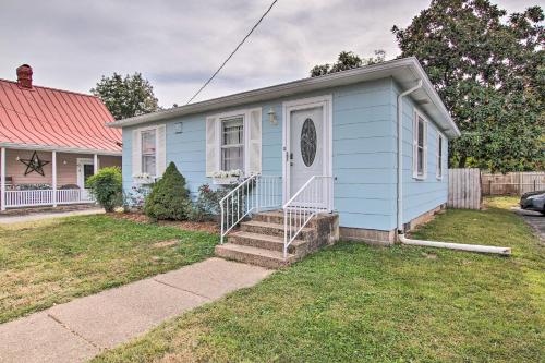 a blue house with a white door and stairs at Cottage with Yard, Walk to Historic Attractions in Sainte Genevieve