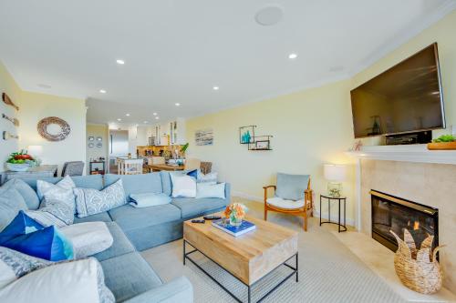 a living room with a blue couch and a fireplace at Seascape Sanctuary in Aptos