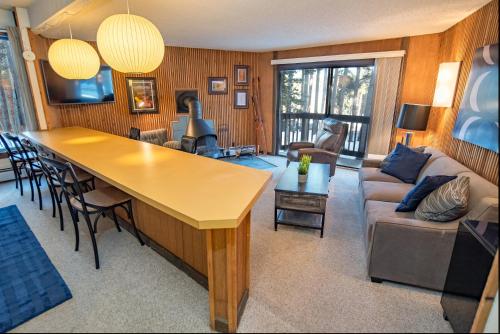 a living room with a couch and a table at Peak 8 Village Getaway Condo: On Shuttle Route in Breckenridge