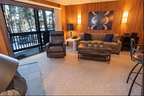 a living room with a couch and a chair at Peak 8 Village Getaway Condo: On Shuttle Route in Breckenridge