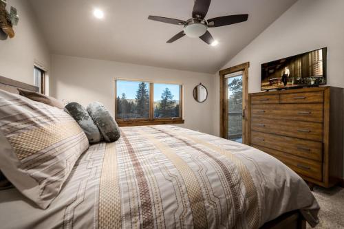 a bedroom with a bed with a ceiling fan and a dresser at Deming Crossing in Frisco