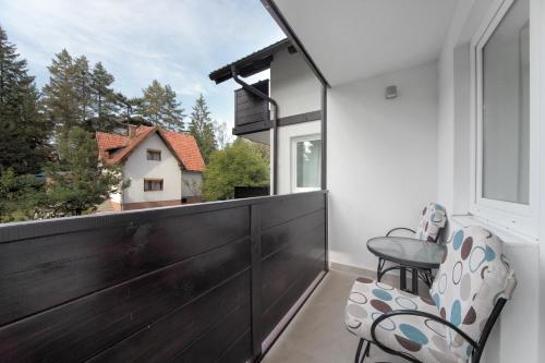 a balcony with two chairs and a window at Vila Bjanka in Zlatibor
