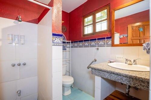 a bathroom with a sink and a toilet at The Grateful Hotel in Playa Grande