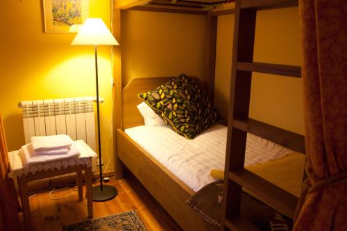 a small bedroom with a bunk bed and a lamp at Hotel Rural Quinta da Geia in Aldeia das Dez