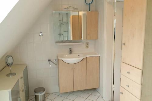 a small bathroom with a sink and a mirror at Störtebecker in Wangerland
