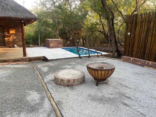 a backyard with a pool and a fire pit at Lion Hill @Kruger in Marloth Park