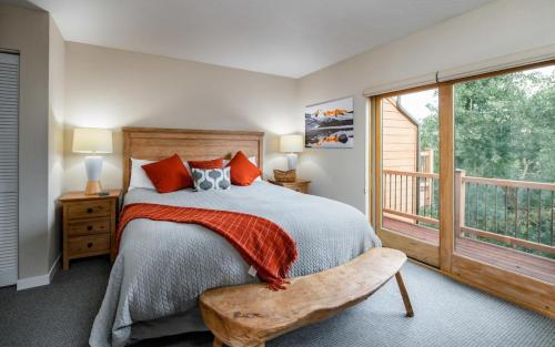 a bedroom with a bed and a large window at Cedars 38 Townhome Ski In Ski Out in Breckenridge