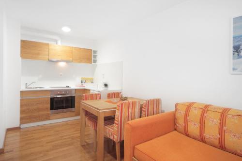 a kitchen and dining room with a table and a couch at Vila Bjanka in Zlatibor