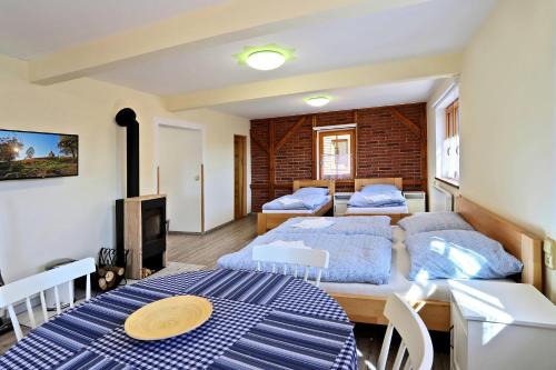 a bedroom with two beds and a living room at Apartments Pavel in Abertamy