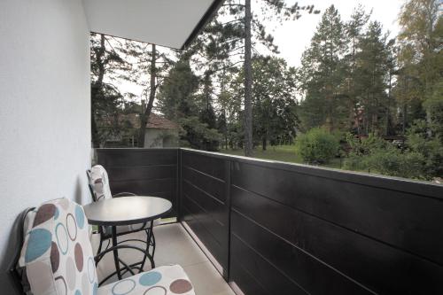 a balcony with a table and chairs and a window at Vila Bjanka in Zlatibor