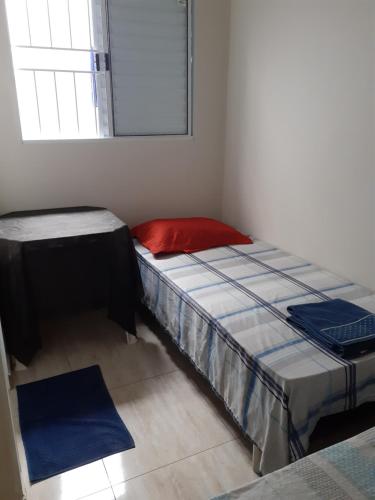 a bedroom with two beds and a window at Pousada Acolhedora in Ribeirão Preto