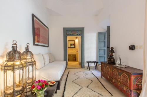 a living room with a white couch and a table at Riad Tchaikana in Marrakech