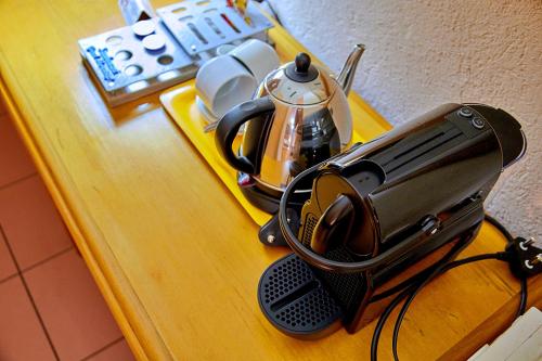 a toaster sitting on a counter with a tea kettle at Sanbonani Hotel in Hazyview