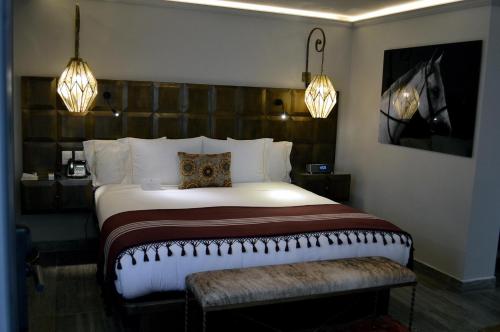 a bedroom with a large bed and two lights at Casa 1810 Hotel Boutique in San Miguel de Allende