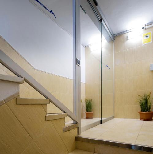a staircase in a building with potted plants at Hostal Costa Blanca in Ibiza Town