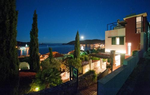 a house with a view of the ocean at night at Villa Tangerine Vis in Vis