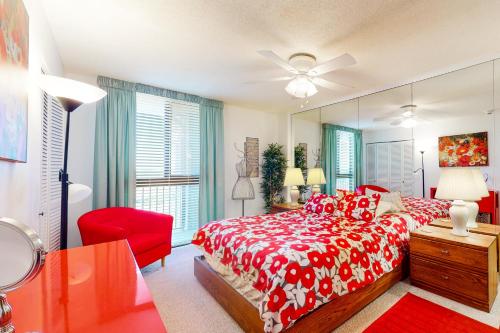 a bedroom with a red bed and a mirror at Sea Colony - 908 Dover House Rd in Bethany Beach