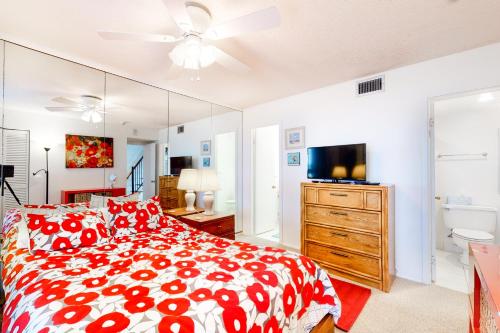 a bedroom with a red and white bed and a mirror at Sea Colony - 908 Dover House Rd in Bethany Beach