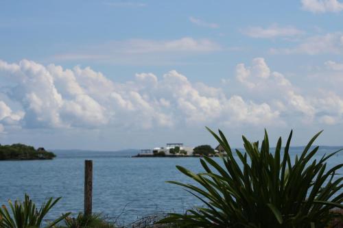 a view of a large body of water with a house at Eco Hotel Las Palmeras in Isla Grande