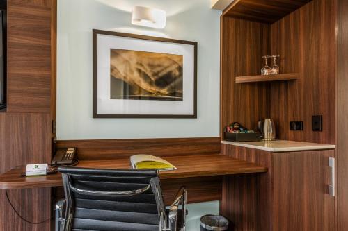 a home office with a desk and a chair at Holiday Inn Queenstown Frankton Road, an IHG Hotel in Queenstown