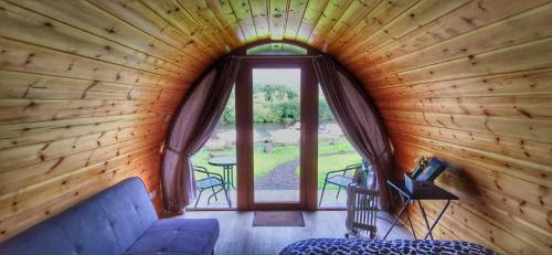 a room with a large window in a log cabin at Glamping Pod Thady Killynick County Fermanagh in Enniskillen