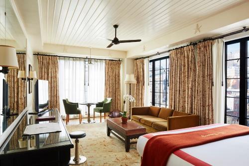 a bedroom with a bed and a living room at The Bowery Hotel in New York