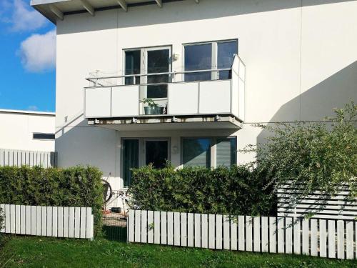 a white house with a fence in front of it at 4 person holiday home in Visby in Visby