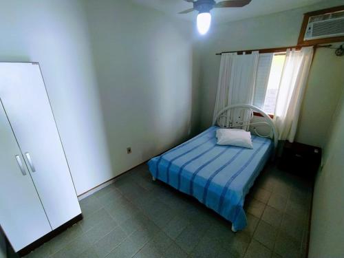 a small bedroom with a bed and a window at Solar Dona Maria in Pinheira