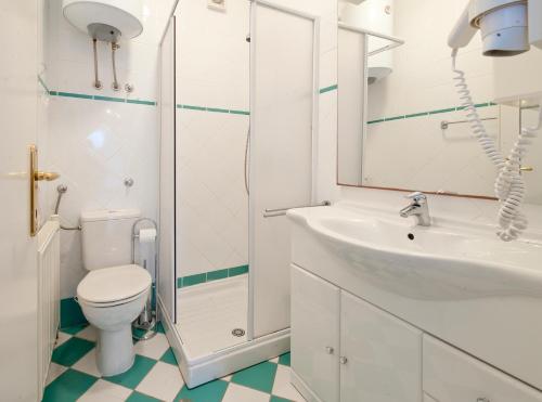 a bathroom with a toilet and a sink and a shower at Villa Tangerine Vis in Vis