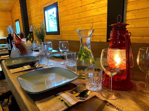 a wooden table with wine glasses and a bottle at Amber Blue Wellness & SPA in Karwia