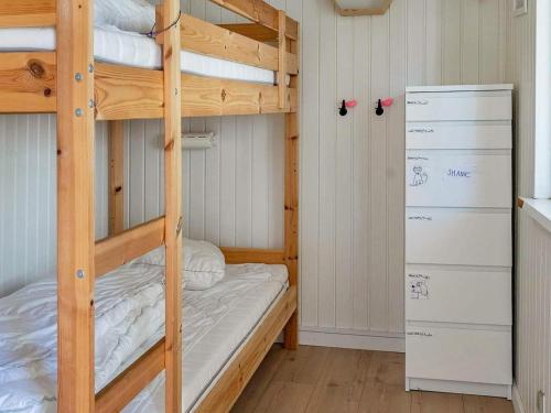 a bunk bed room with two bunk beds and a refrigerator at Holiday home Hals III in Hals