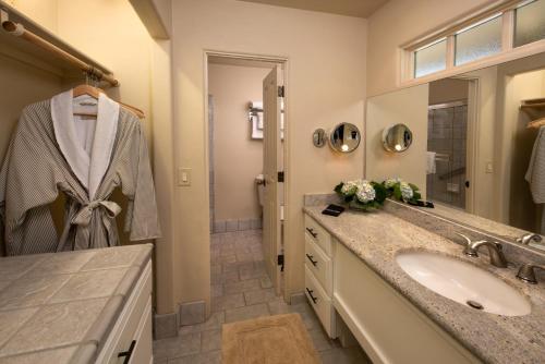 a bathroom with a sink, mirror, and bathtub at Horizon Inn & Ocean View Lodge in Carmel